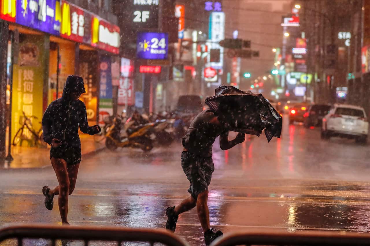Typhoons regularly hit Taiwan this time of the year. Last year people ran during a downpour of rain brought by typhoon Maria.