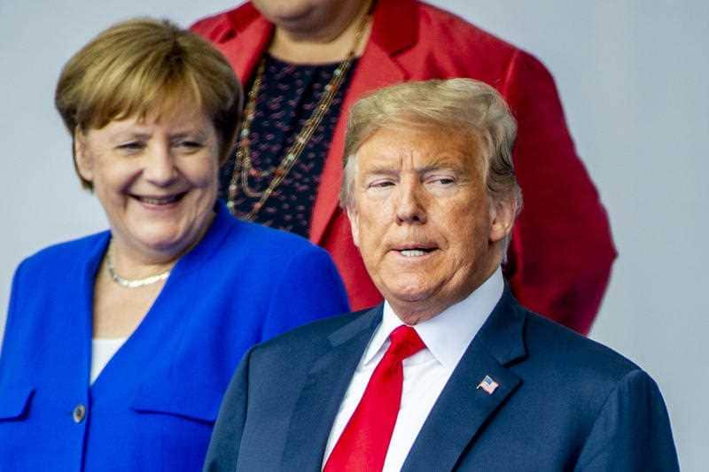 German Chancellor Angela Merkel, President Donald J. Trump stand together as they gather for a family picture during a NATO summit in Brussels, Belgium, July 11, 2018. 