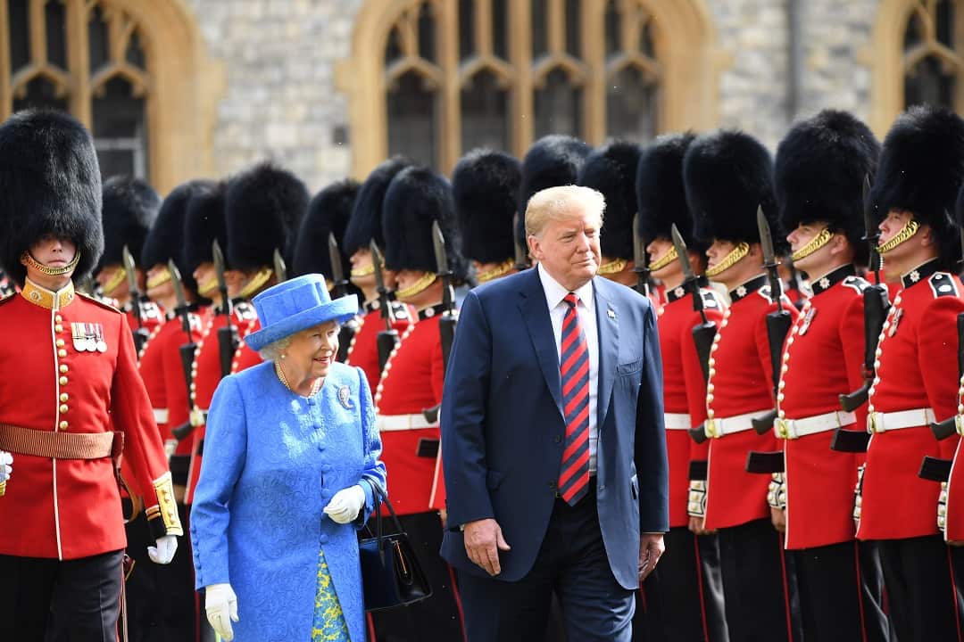 President Donald Trump and Queen Elizabeth II. The US president says he was not late to their meeting.