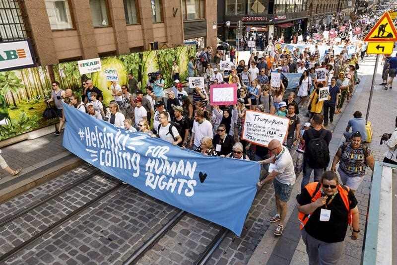 People take to Helsinki street, Sunday, July 15, 2018. Some 1,500 people are protesting in Helsinki to promote human and sexual rights.