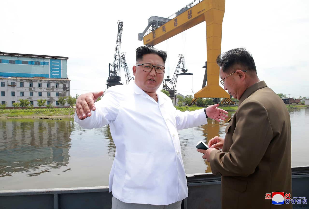 North Korean leader Kim Jong Un, left, gestures during his visit to a shipyard in North Hamgyong Province, North Korea.