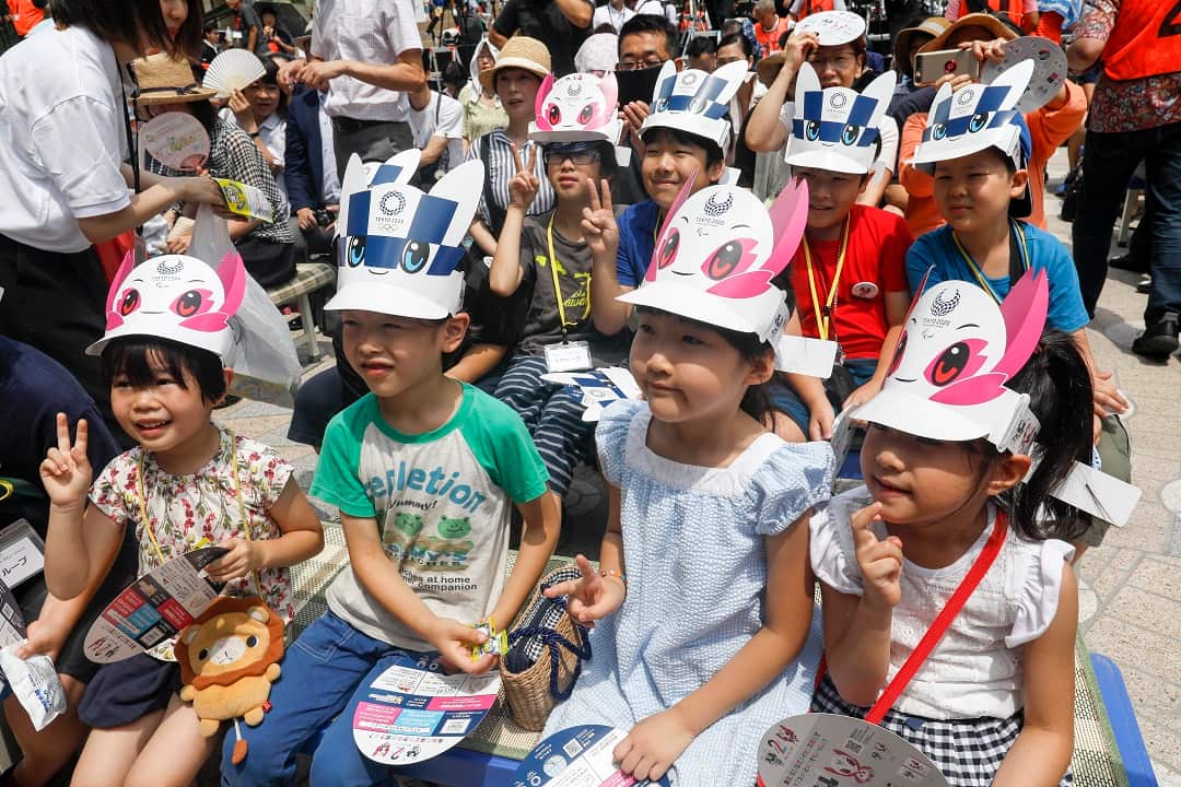 Children wait for the debut of Tokyo 2020 mascots.