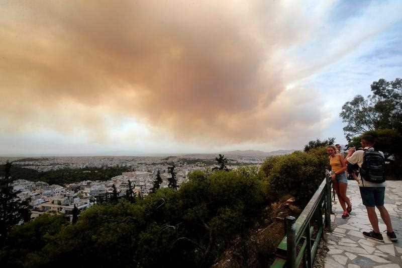 Thick clouds of smoke dominate the sky due to fires on the mountain slopes of Gerania, near Kineta, a beach town some 54 kilometers west of Athens, Greece, 23 July 2018.