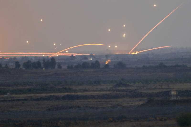 Fire trails and explosions from the fighting between forces loyal to Syrian President Bashar Assad and rebels in southern Syria as seen from the Israeli-controlled Golan Heights, Wednesday, July 25, 2018.