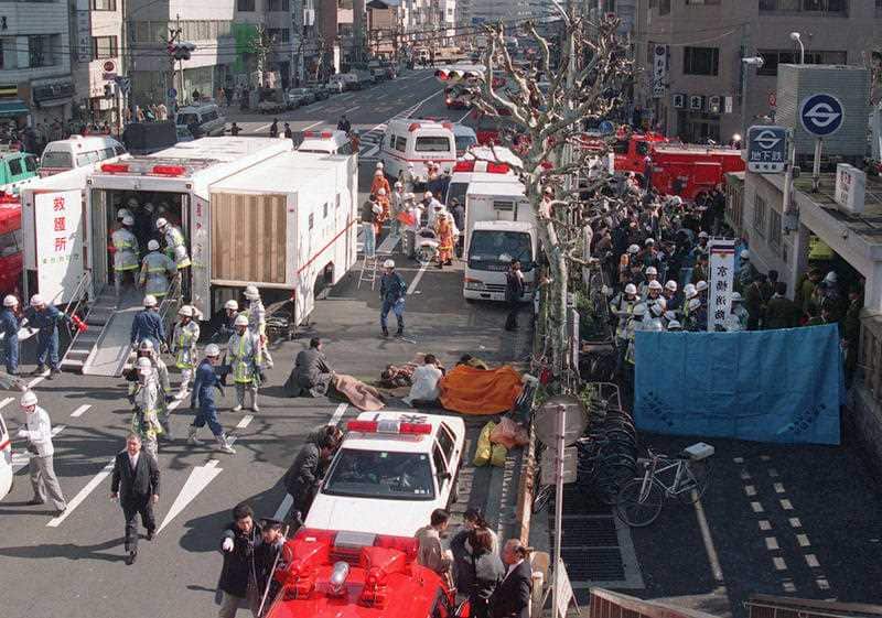 In this March 20, 1995, file photo, subway passengers affected by sarin nerve gas are treated near Tsukiji subway station, right, in Tokyo.
