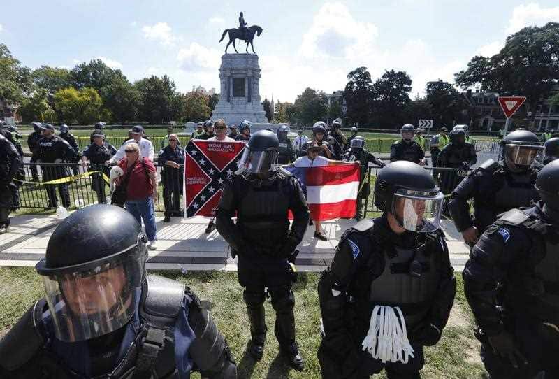 State Police keep a handful of Confederate protesters separated from counter demonstrators in front of the statue of Confederate General Robert E. Lee.