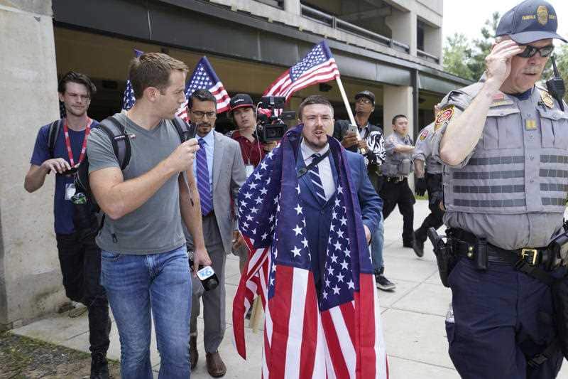 White supremacist Jason Kessler arrives at the Vienna metro station in Vienna, Va., Sunday, Aug. 12, 2018.