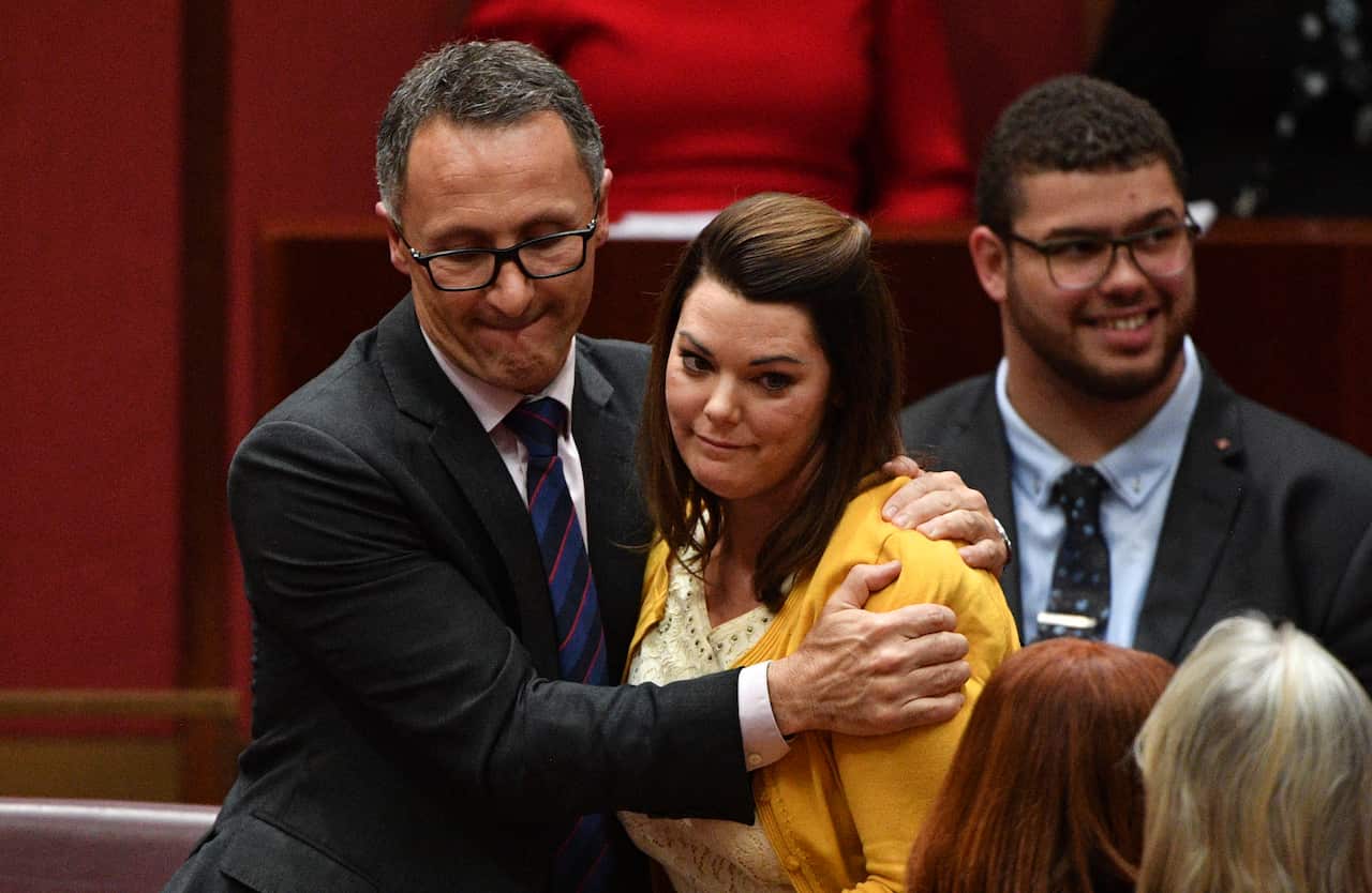 Greens leader Senator Richard Di Natale hugs Greens Senator Sarah Hanson-Young after a censure motion against Liberal Democratic Party Senator David Leyonhjelm.