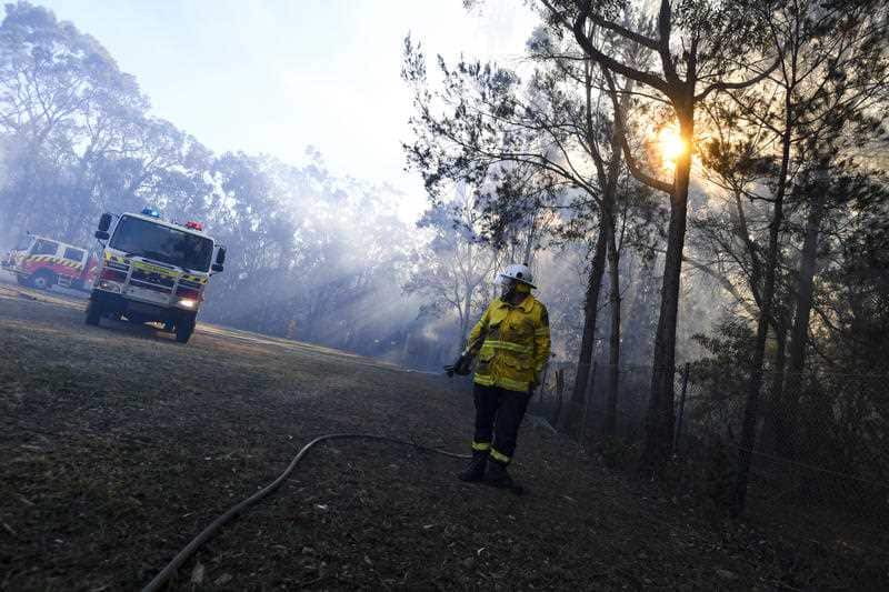 NSW fire fighters work on containing an out of control bushfire in Bomaderry near Nowra, Wednesday, August 15, 2018.