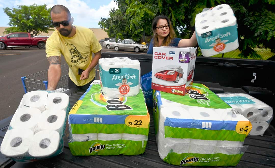 Bryce and Dom Boeder of Waimea, Kauai, load their truck with storm supplies.