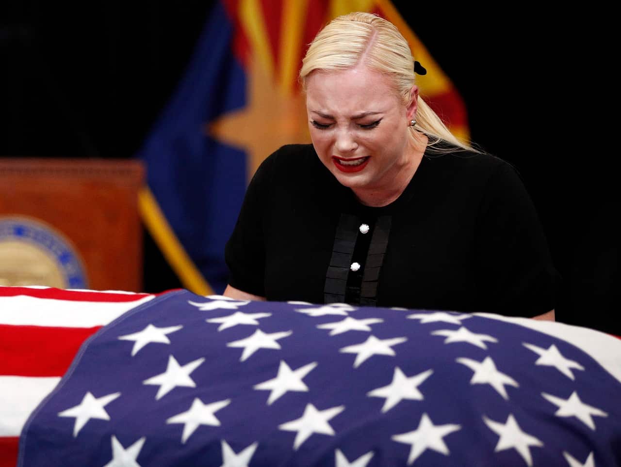 Meghan McCain cries at the casket of her father.