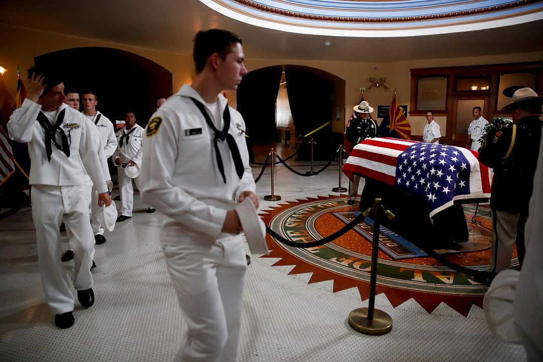 US Naval sea cadets walk past the casket during a memorial service for John McCain.