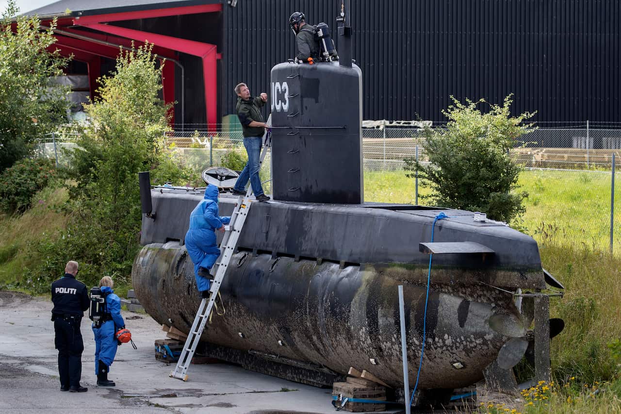 A file photo of police technicians boarding submarine UC3 Nautilus on a pier in Copenhagen harbor, Denmark, 13 August, 2017.