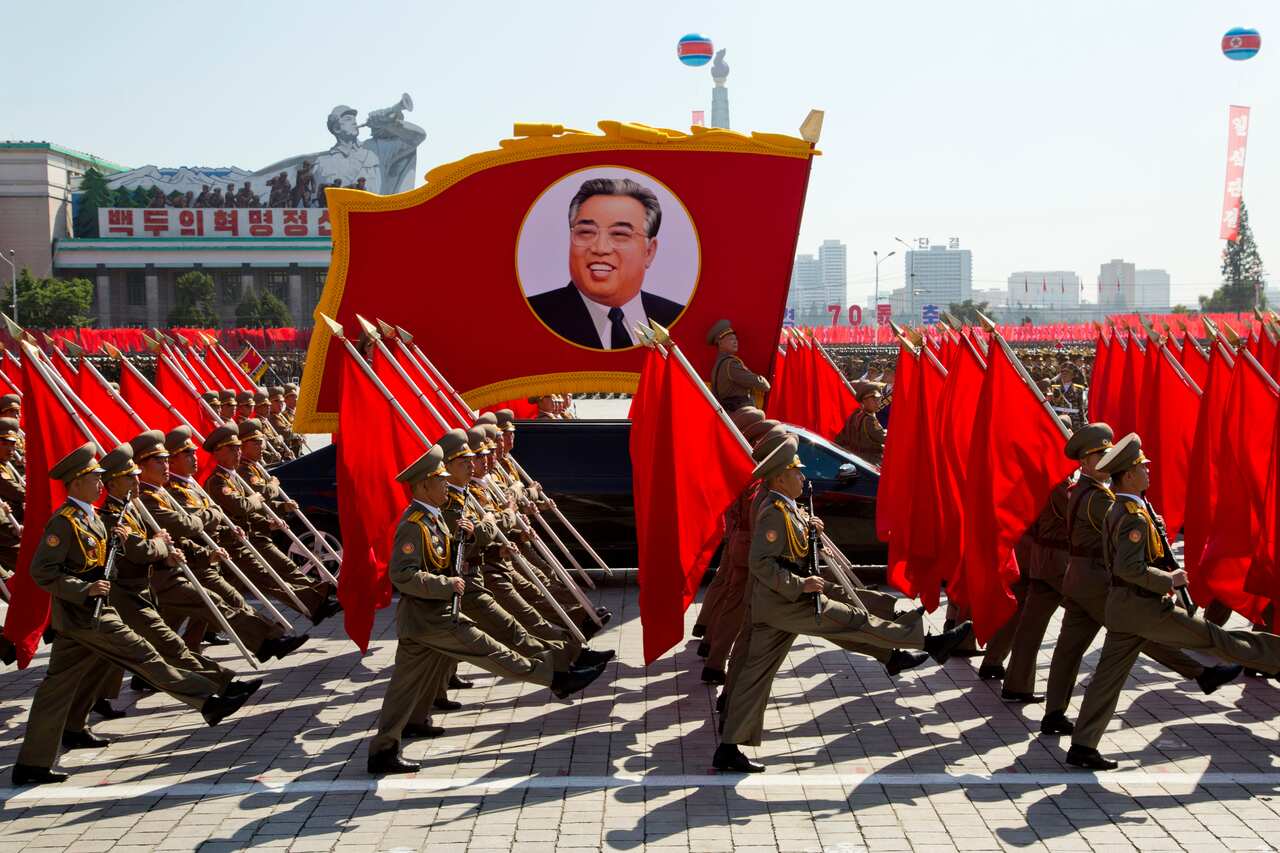 Soldiers march with a float showing late North Korean leader Kim Il Sung during a parade for the 70th anniversary of North Korea's founding day in 2018.