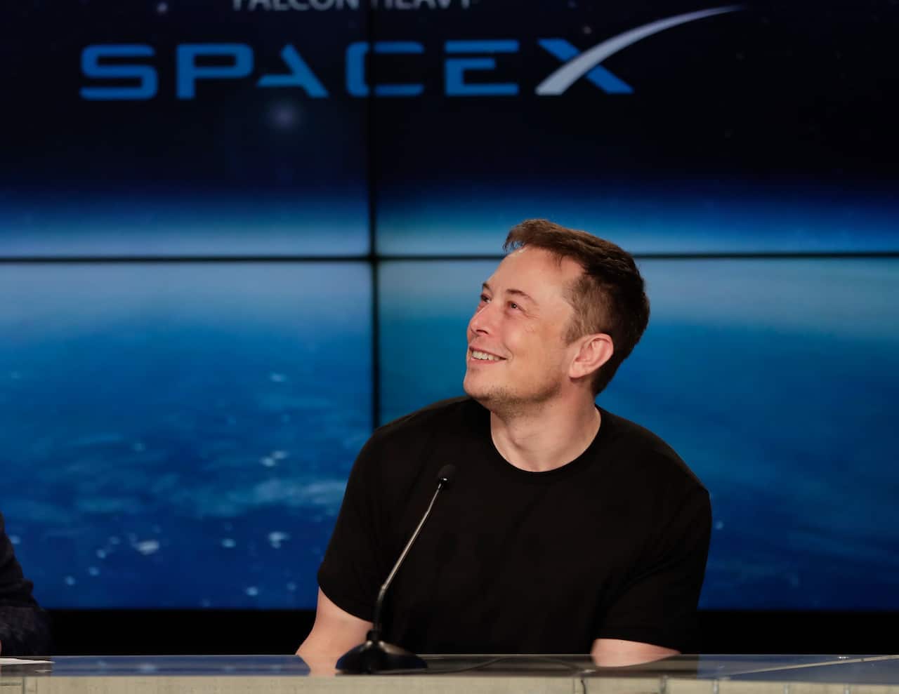 Elon Musk, founder, CEO, and lead designer of SpaceX, speaks at a news conference after the Falcon 9 SpaceX heavy rocket launched successfully.