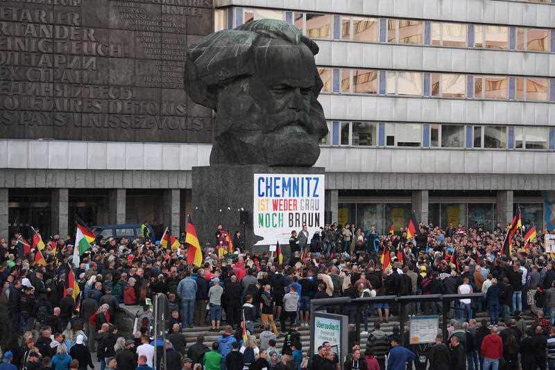 Supporters of the right-wing group Citizens' Movement Pro Chemnitz protest in front of the Karl Marx Monument in Chemnitz.