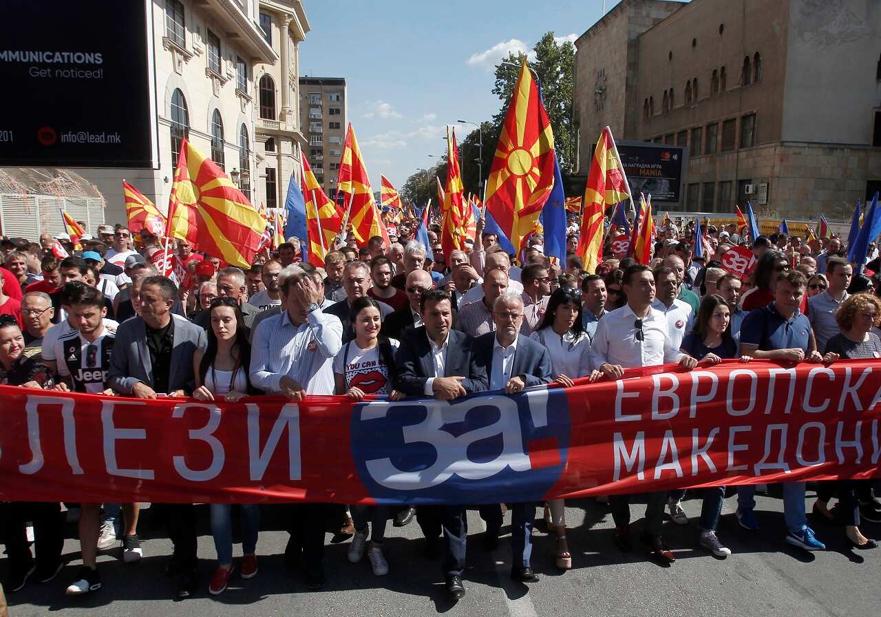 Macedonian Prime Minister Zoran Zaev takespart in a march holding a banner that reads "Come out for European Macedonia".
