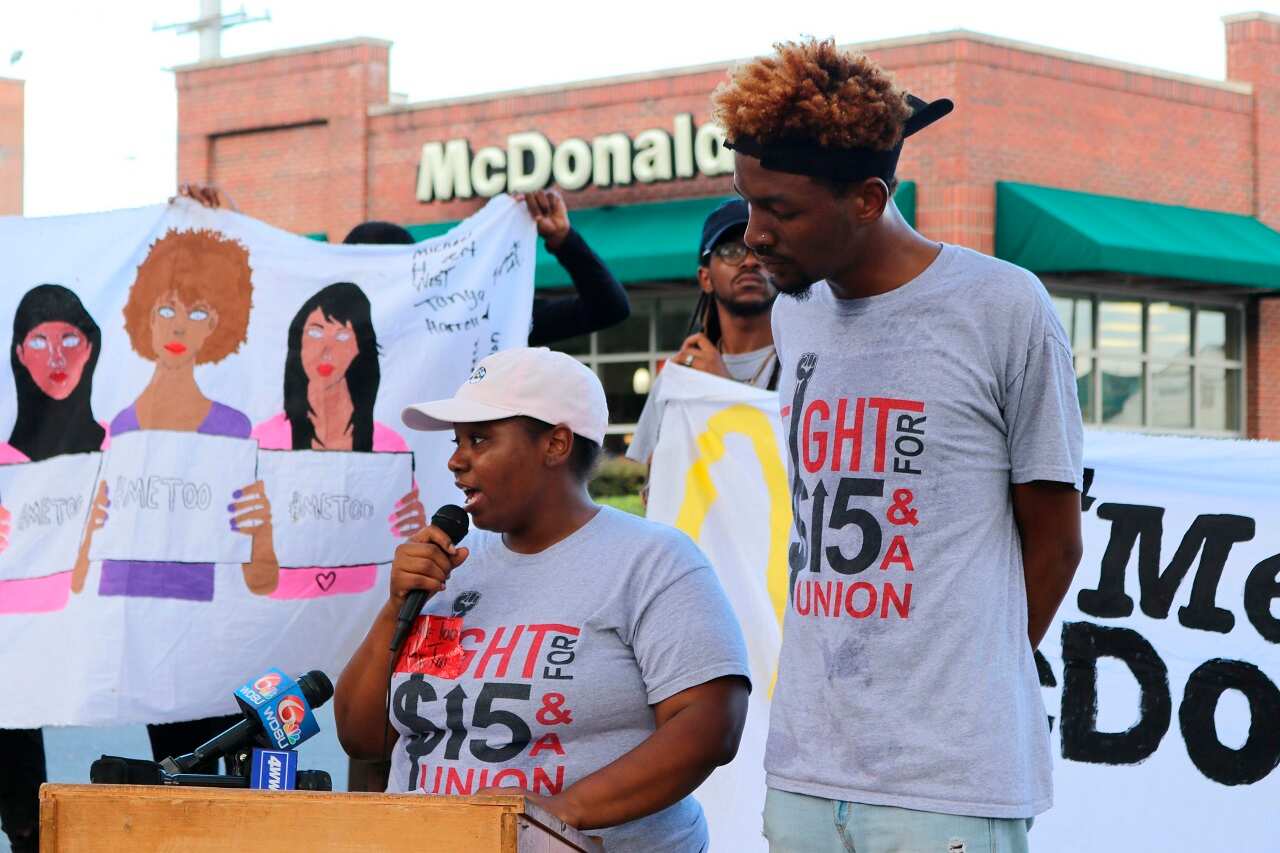 McDonald's employee Tanya Harrell speaks while former McDonald's employee Michael Hebert looks on.