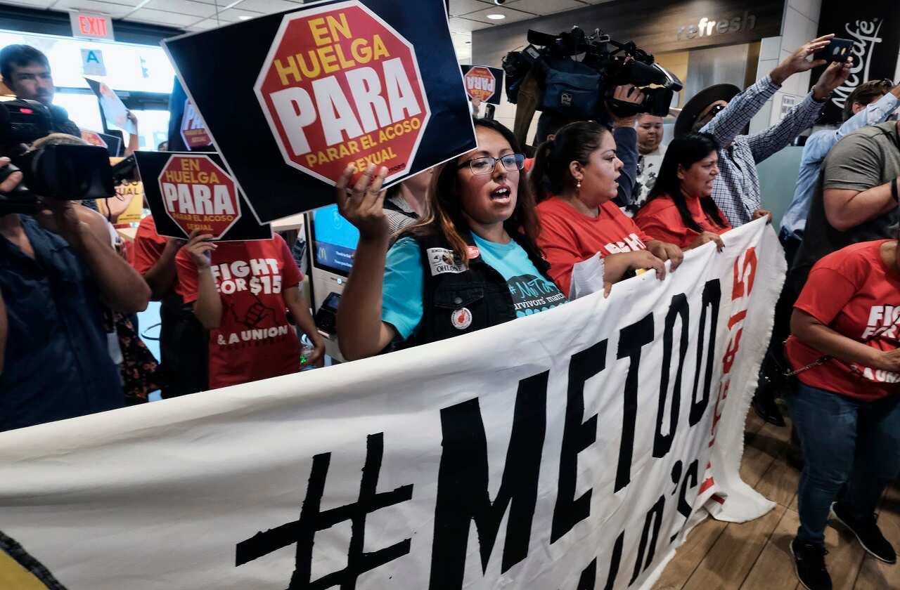 McDonald's workers protest inside of a McDonald's restaurant in LA.
