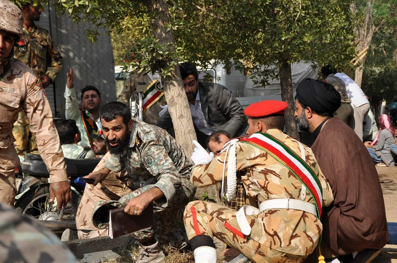 Iranian armed forces members and civilians take shelter.