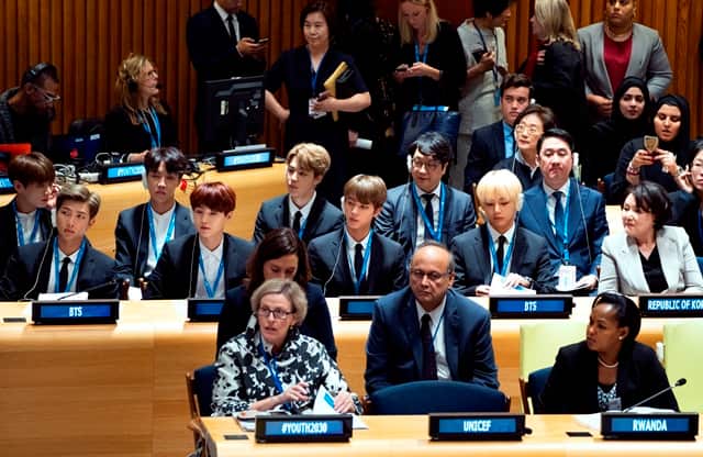 Members of the Korean K-Pop group BTS, center row, attend a meeting at the U.N. high level event regarding youth during the 73rd session of the United Nations General Assembly, at U.N. headquarters, Monday, Sept. 24, 2018. (AP Photo/Craig Ruttle)