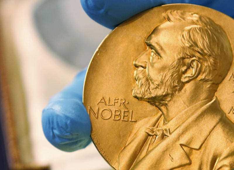  In this April 17, 2015, file photo a national library employee shows the gold Nobel Prize medal awarded to the late novelist Gabriel Garcia Marquez, in Bogota, Colombia.