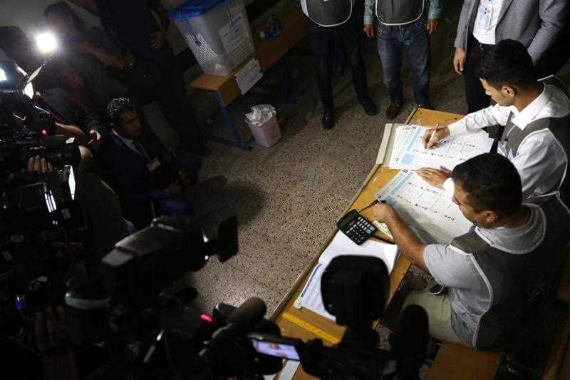 Election officials close a polling station to start the counting as the voting period comes to an end during the Kurdistan parliamentary election in Erbil, the capital of the Kurdistan Region in Iraq, 30 September 2018.