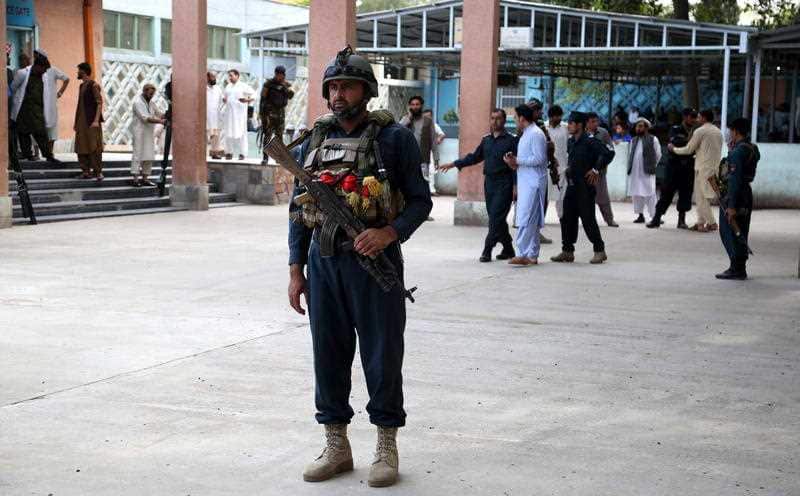Afghan security officials secure the hospital after injured victims of the suicide bomb attack at an election campaign in Kama