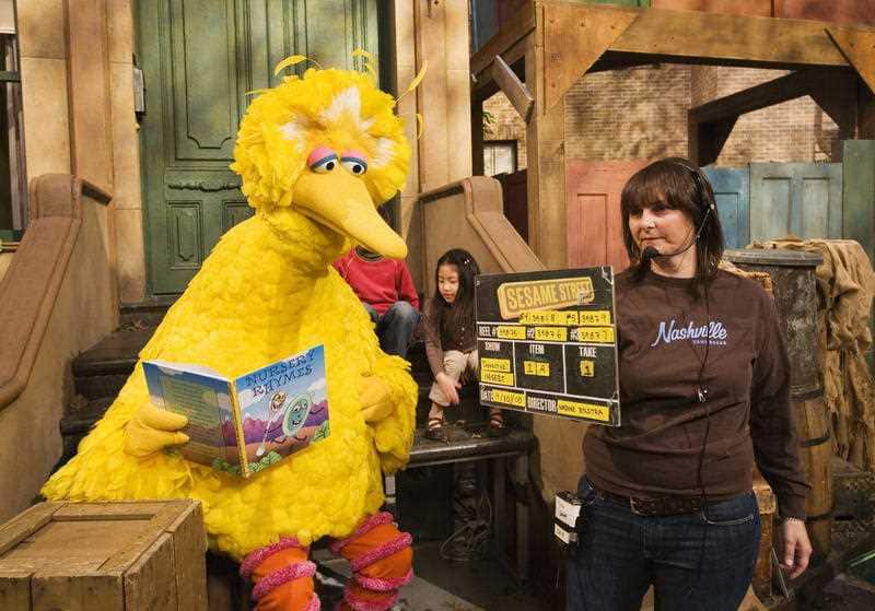 In this April 10, 2008, file photo Lynn Finkel, stage manager for "Sesame Street" slates a taping with Big Bird in New York.