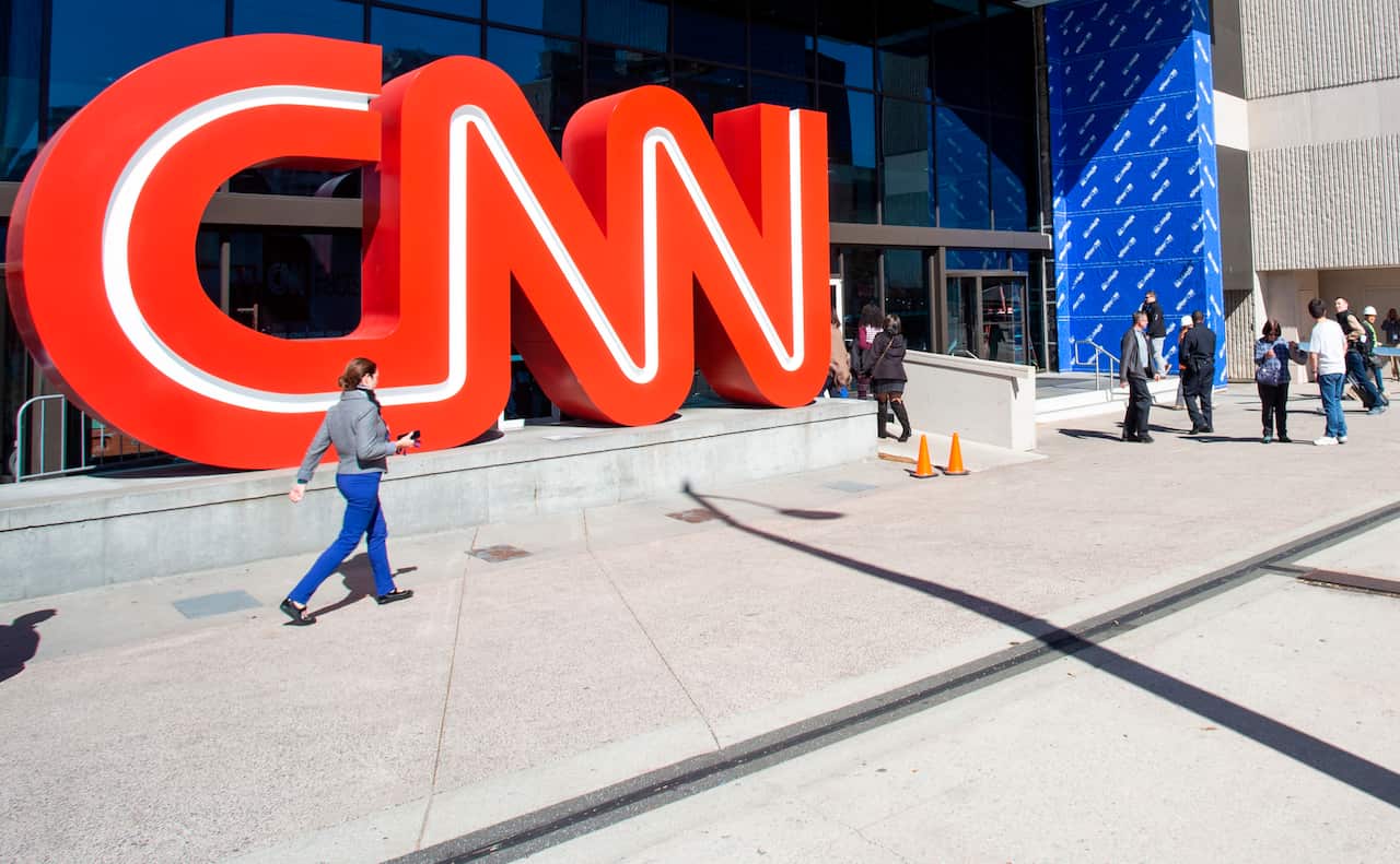 People walk outside CNN Center, Wednesday, Oct. 24, 2018, in Atlanta.