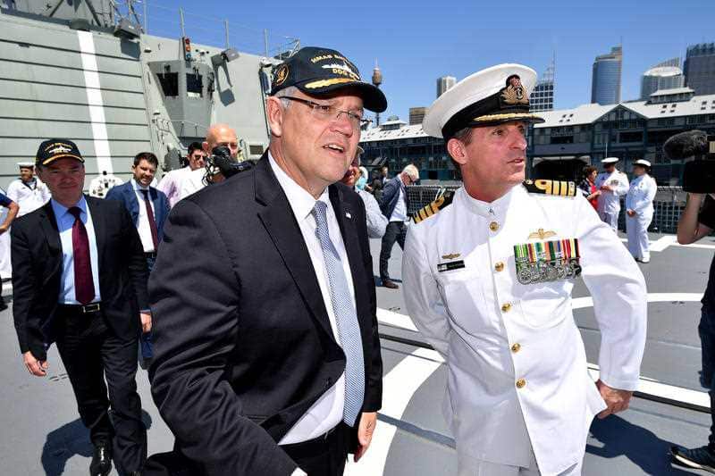 Prime Minister Scott Morrison greets Navy personnel onboard HMAS Brisbane in Sydney, Saturday, Oct. 27, 2018.