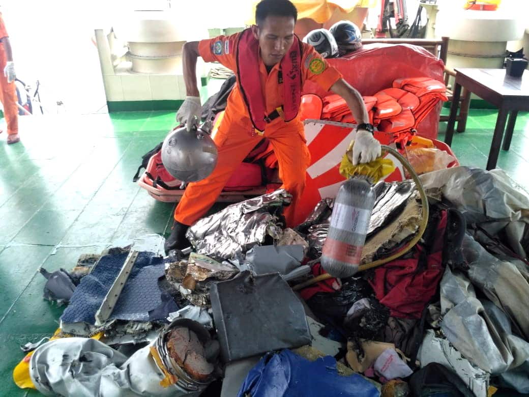 Indonesian rescuer moves parts from a crashed Lion Air passenger plane in waters off Tanjung Karawang, West Java.