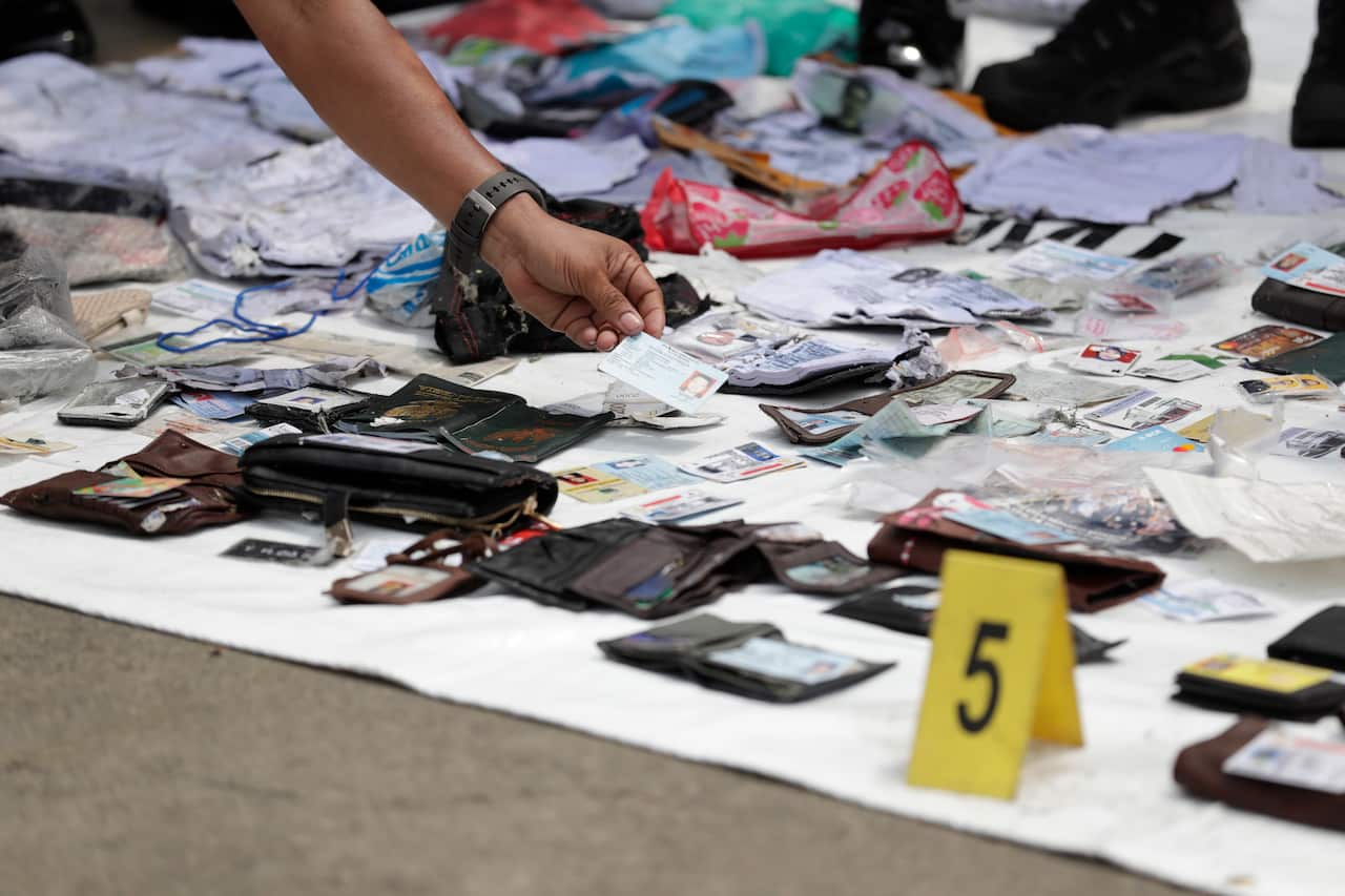 Indonesian rescuers collect and classify wreckage pieces and passenger belongings.