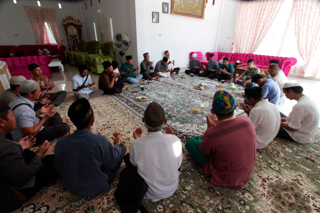 Relatives hold a prayer session at the house of one of the passengers of Lion Air flight JT610.