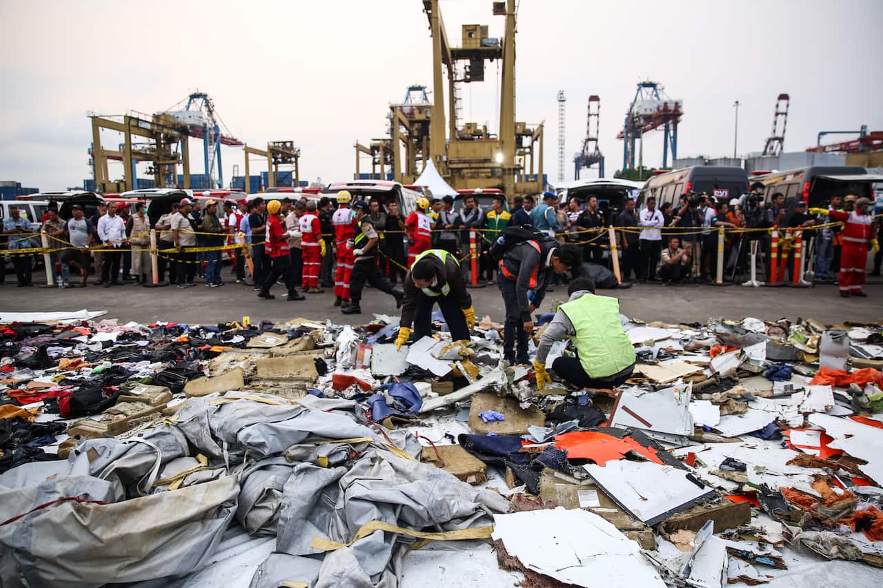 A rescue team collect debris from a crashed plane at Tanjung Priok Harbour, Jakarta, Indonesia, on Tuesday, October 30, 2018.
