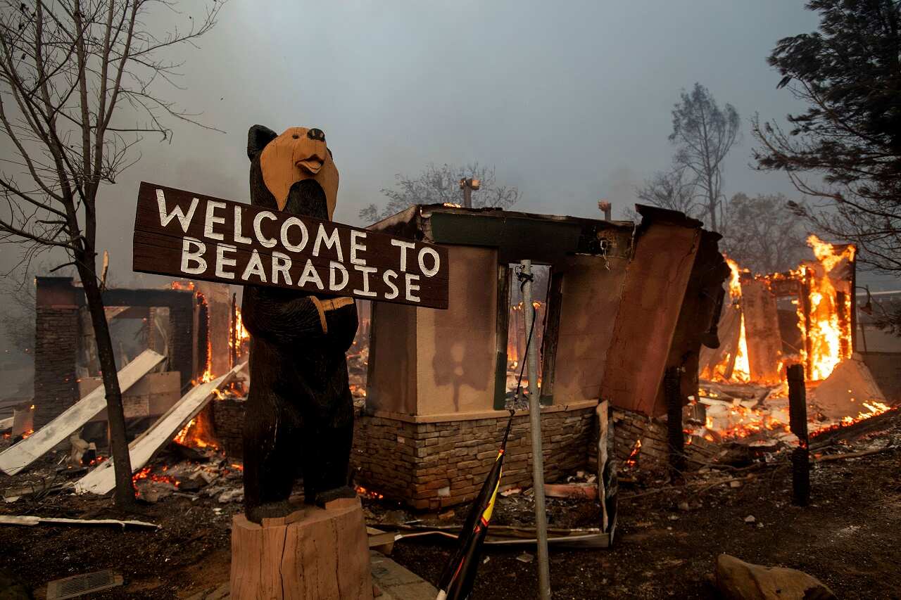 Flames consume a building as the Camp Fire tears through Paradise, California.