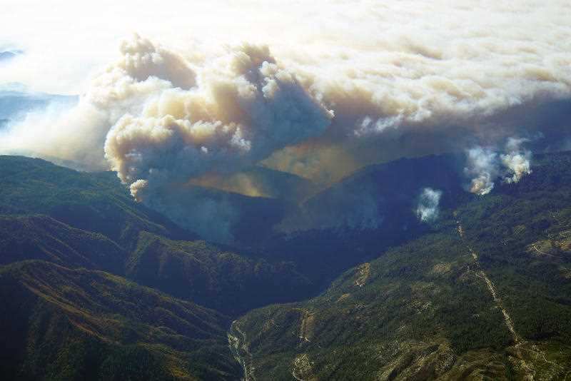 Heavy smoke blankets the forest where the Camp Fire is burning heavily near Paradise, California, on Nov. 11, 2018.