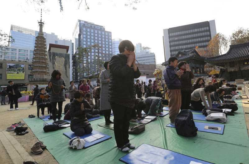 Junior students pray for their senior students' success in the college entrance exams in front of an exam hall in Seoul, South Korea.