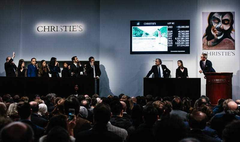 An auction is conducted for the painting 'Portrait of an Artist (Pool with Two Figures)' by artist David Hockney (C).