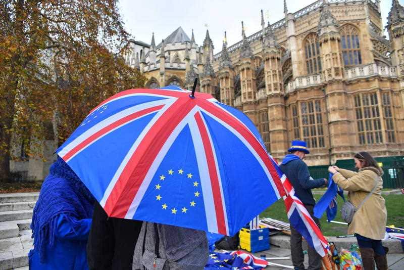 EU and Union flags are waved outside the Parliament to protest against Brexit.