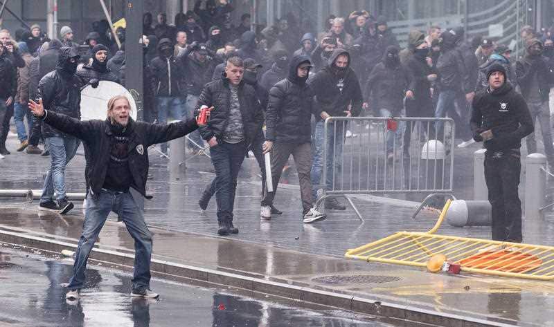 Protestors face off against the police during an anti-migrant demonstration outside of EU headquarters in Brussels.