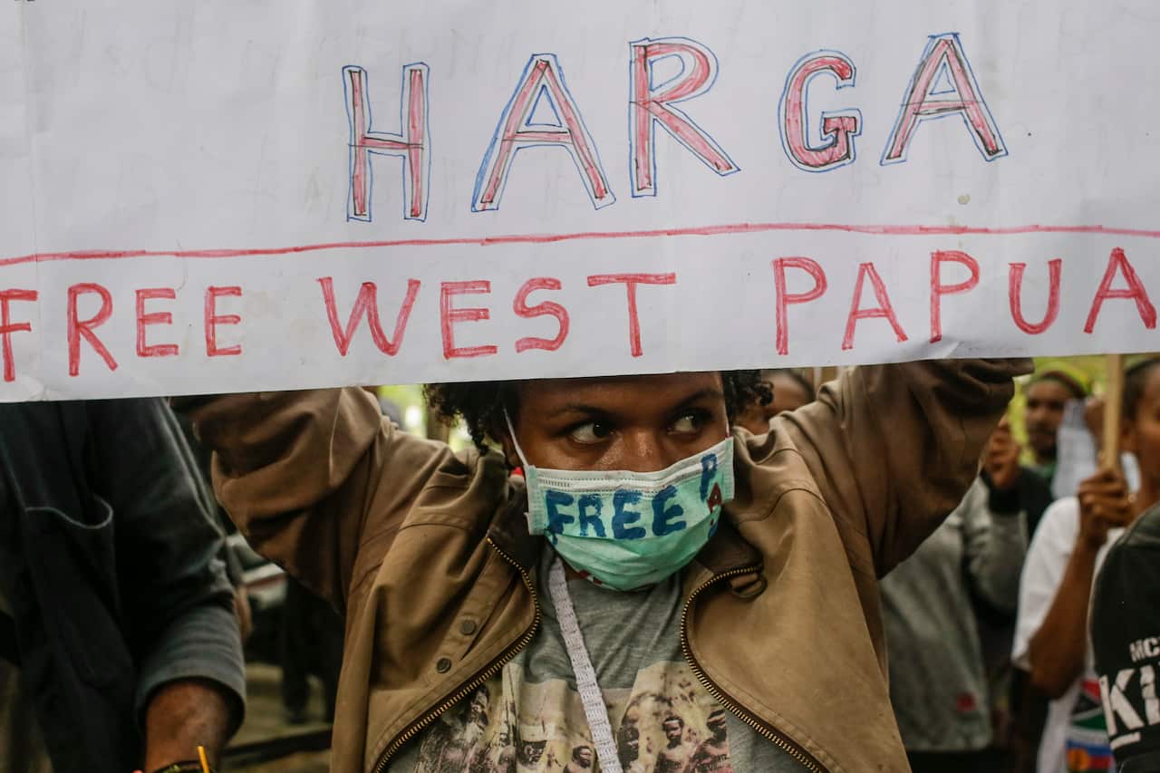 An West Papuan activist hold banners during a rally in Denpasar, Bali, Indonesia.