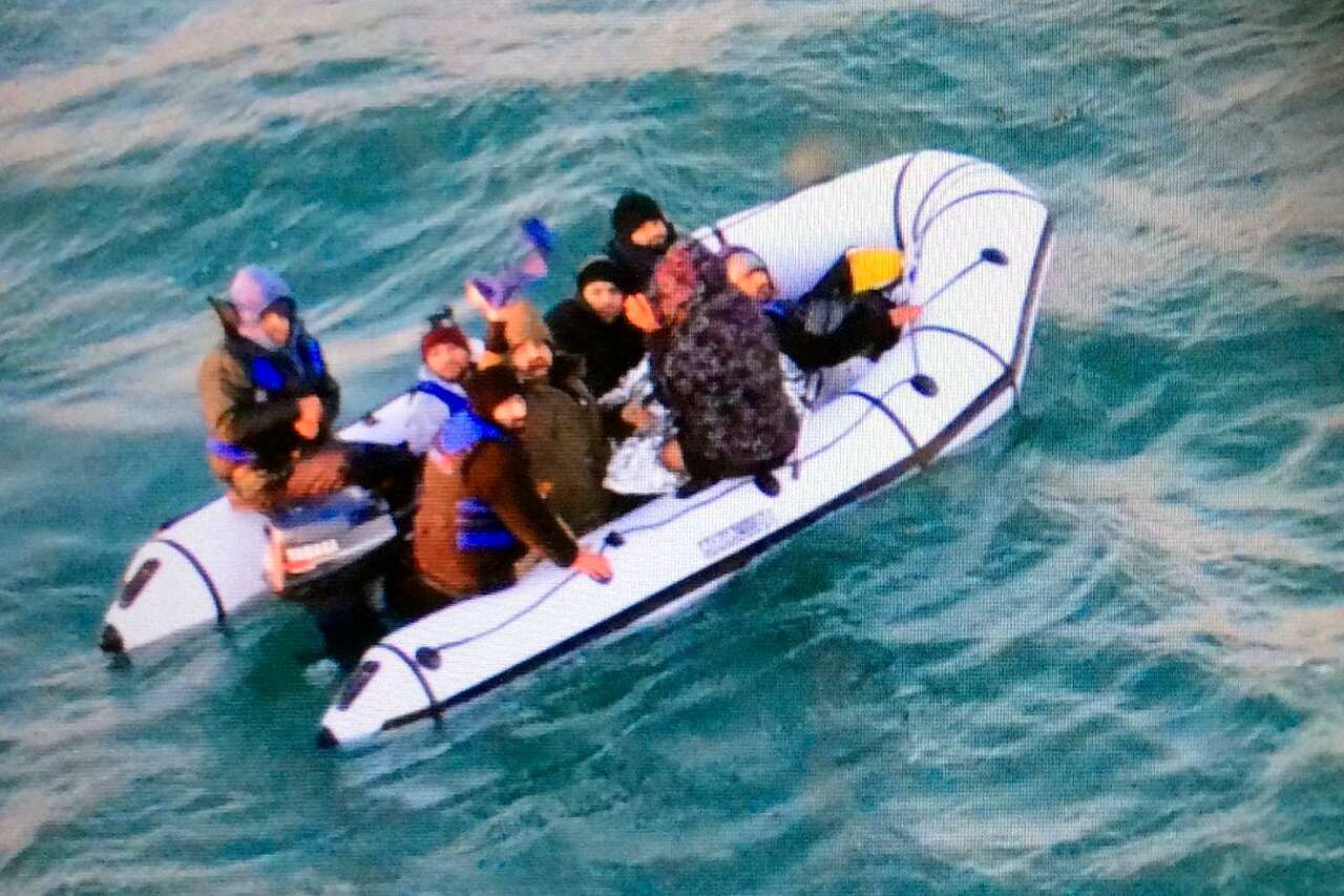 Migrants aboard a rubber boat after being intercepted by French authorities.