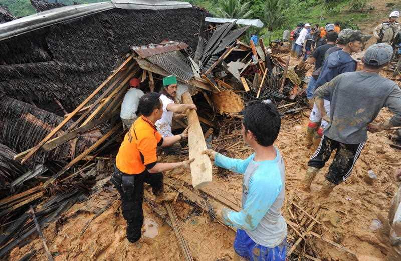 Indonesian villigers and rescuers search for landslide victims at Sirnaresmi village in Sukabumi, Indonesia.
