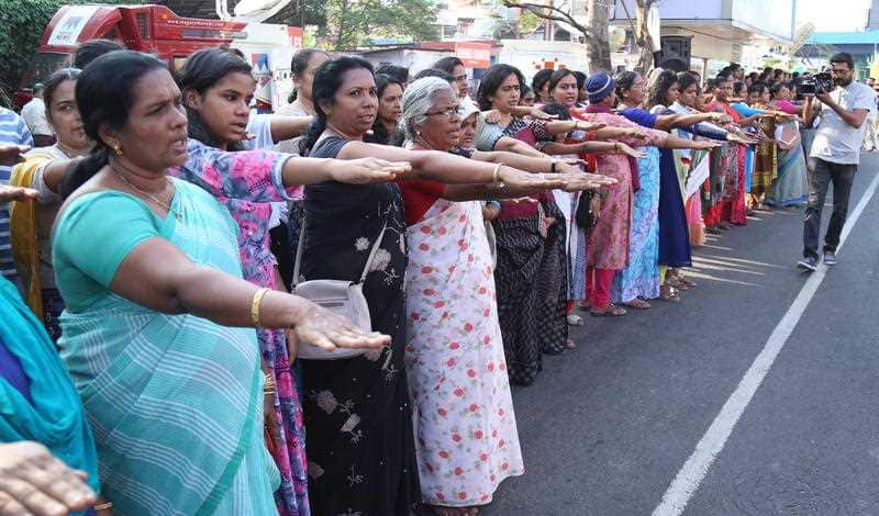 Indian women rise their hands as they pledge to protect the renaissance values and gender equality while participating in the 'Women's Wall' in Kochi, India.