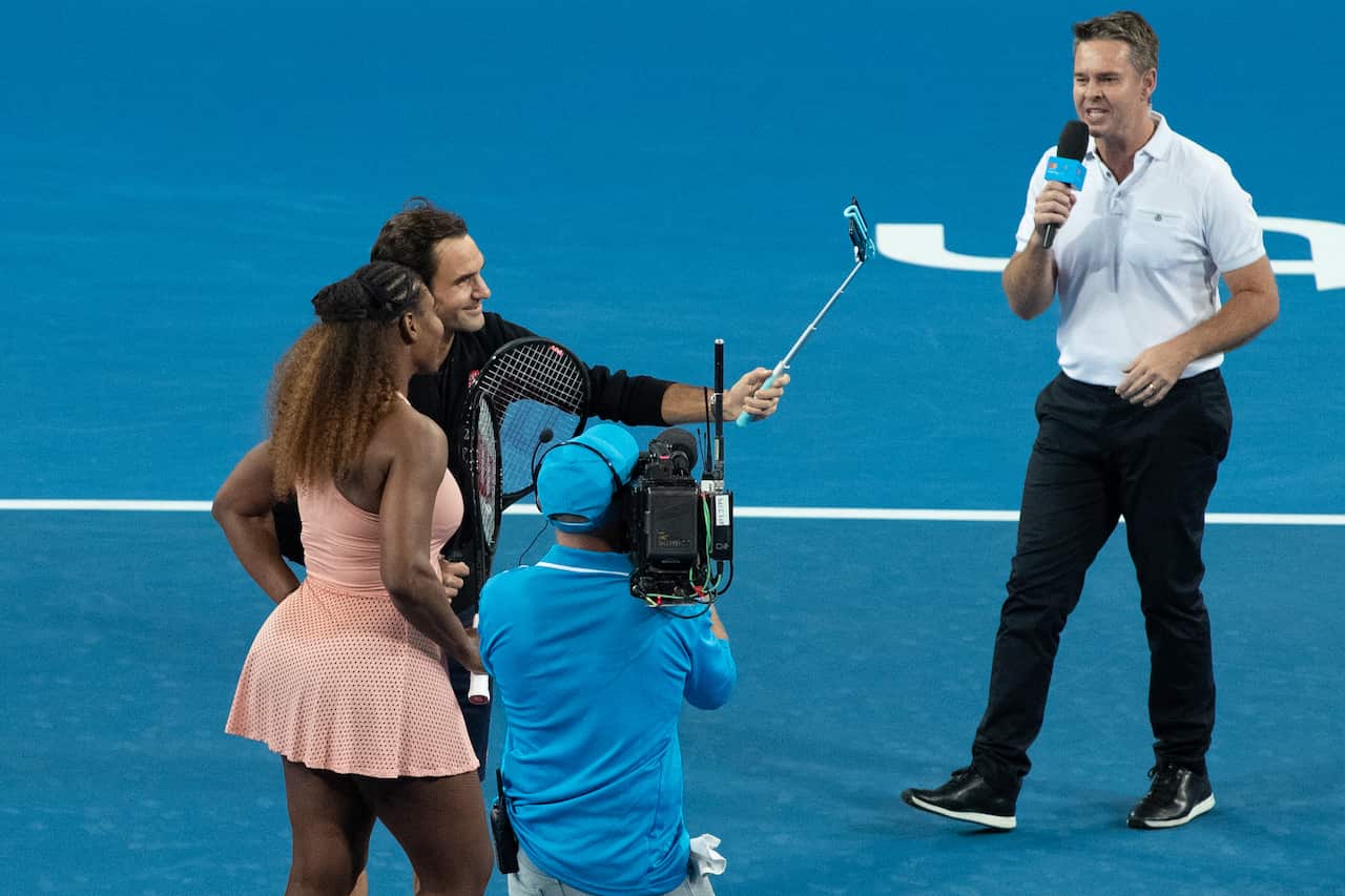 Roger Federer of Switzerland and Serena Williams of the USA take a selfie on court