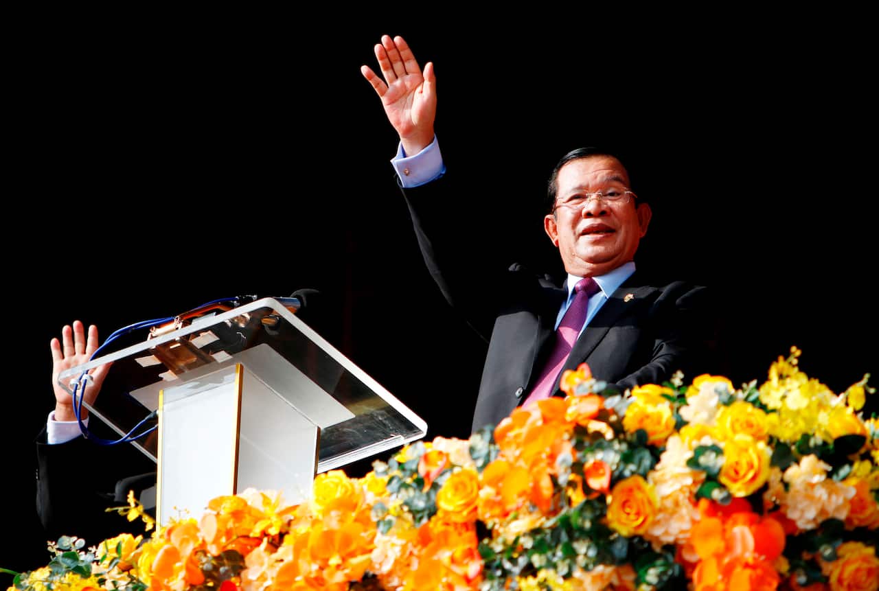 Cambodian Prime Minister Hun Sen waves to the crowd in Phnom Penh during an event commemorating the 40th anniversary of the downfall of the Khmer Rouge regime.