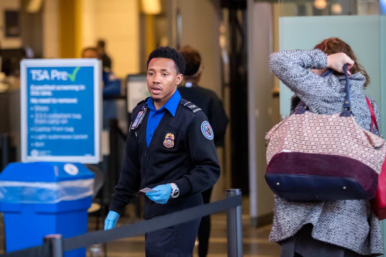 A Transportation Security Agency (TSA) agent checks the identification of air travelers.