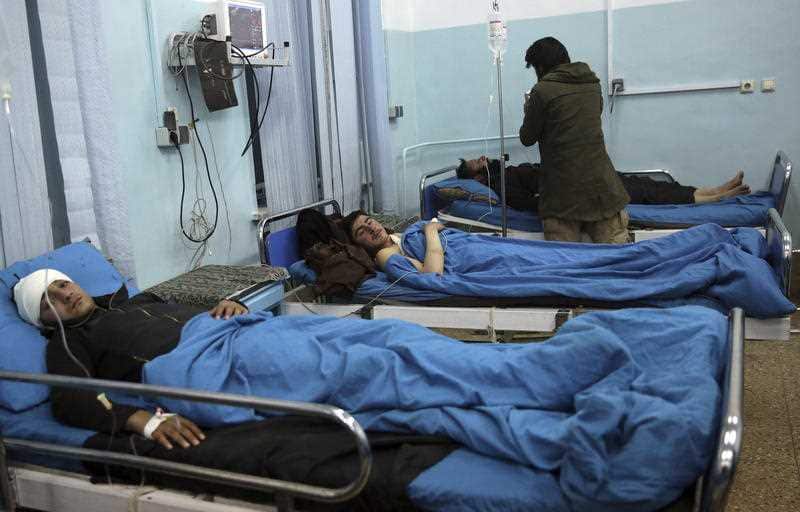 Wounded men lie on beds in a hospital in Kabul following the attack.