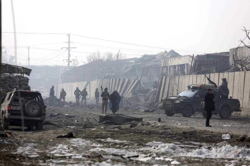 Afghan security forces gather at the site of the attack the day after.